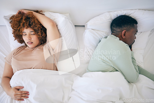 Image of Top view, sleeping and black couple in bed in morning after fighting, argument and relationship problem. Depression, dating and male in bed with woman with sexual frustrated, infertility and stress