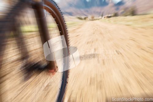 Image of Cycling wheel, motion blur and fitness in nature, countryside and training of triathlon, sports and power. Closeup bicycle, speed and outdoor adventure for off road freedom, bike exercise and action