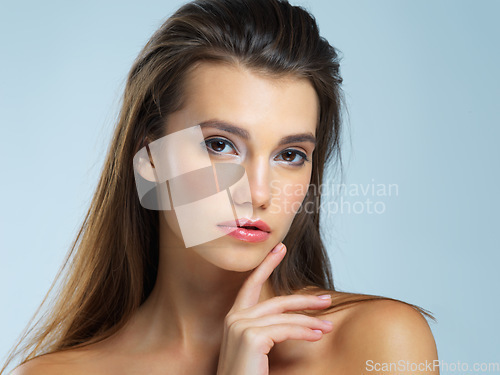 Image of Face, serious and portrait of woman with beauty on blue background for wellness, skincare and spa treatment. Salon aesthetic, dermatology and face of confident girl with cosmetics, makeup and facial