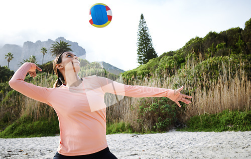 Image of Volleyball, beach and spike with a sports woman playing a game outdoor in nature alone for recreation. Fitness, exercise and training with a female athlete hitting a ball during a match on the coast