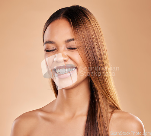 Image of Woman, beauty and hair care while laughing in studio for growth and shine shampoo on a brown background. Aesthetic female happy for natural keratin treatment and wellness with skincare and haircare