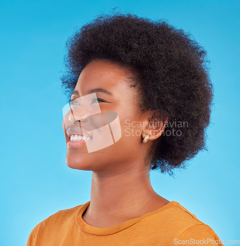 Image of Thinking, smile and happy black woman wondering looking away in thought isolated against a blue studio background. Afro, casual and face of young African American female relax, calm and confident