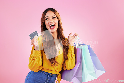 Image of Woman with shopping bag, retail and happy with credit card for payment and commerce on pink background. Customer, buy product at store or boutique, sale or promotion, female with smile in studio