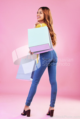 Image of Woman with shopping purchase, paper bag and happy with retail on pink background. Happiness, customer experience with discount and promotion, fashion product and female with smile in studio