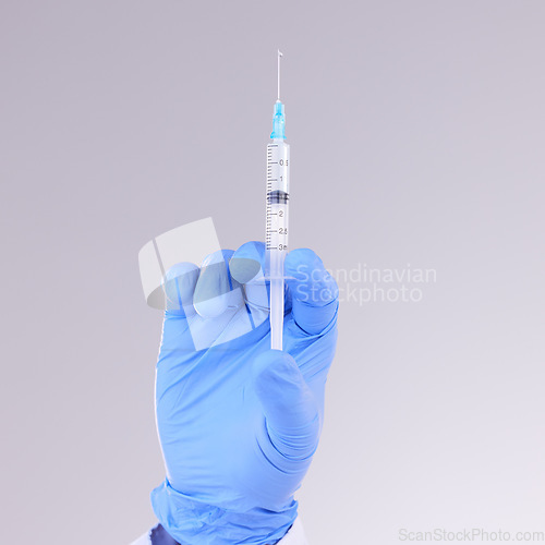 Image of Hands, vaccine and healthcare with a doctor in studio on a gray background holding monkeypox treatment. Medical, innovation and insurance with a medicine professional ready to administer a cure