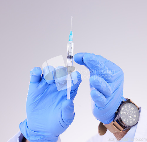 Image of Hands, vaccine and healthcare with a doctor in studio on a gray background holding monkeypox treatment. Medical, innovation and insurance with a medicine professional ready to administer a cure