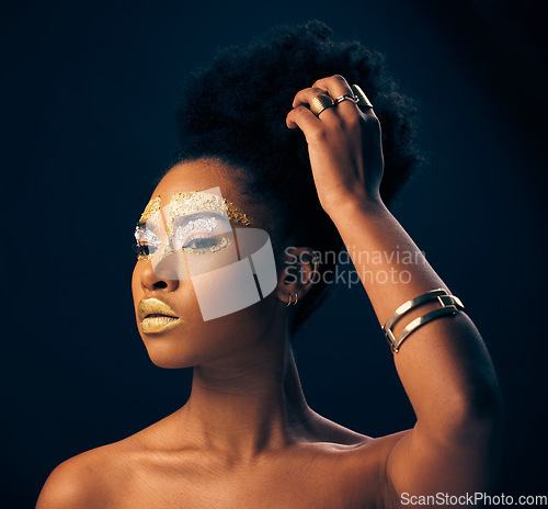 Image of Beauty, gold and glitter with black woman and makeup in studio for luxury, cosmetics or African pride. Natural, creative and goddess with female model on black background for queen, bronze or glamour