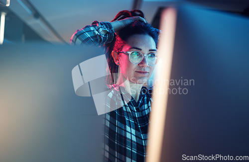 Image of Cybersecurity, malware and woman hacker working on a computer in the basement at night for phishing. Database, password and ransomware with a female coder hacking a digital transformation network