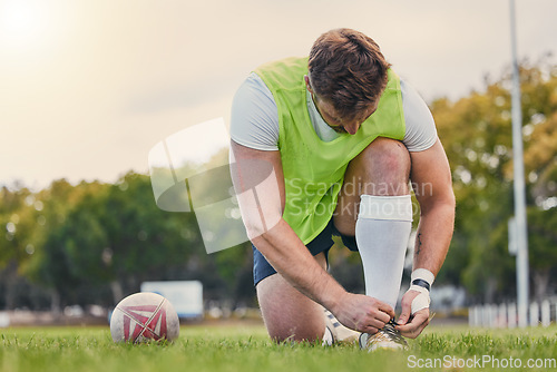 Image of Sports, soccer and man tie shoelace, training and workout for balance, wellness and healthy lifestyle. Male player, guy or athlete tying shoe, fitness and practice for match, exercise and performance