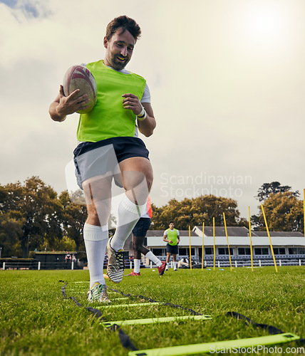 Image of Rugby, sports and man training on field with equipment ready for match, practice and sport games. Fitness, performance and happy male athlete running for warm up, exercise and workout for competition