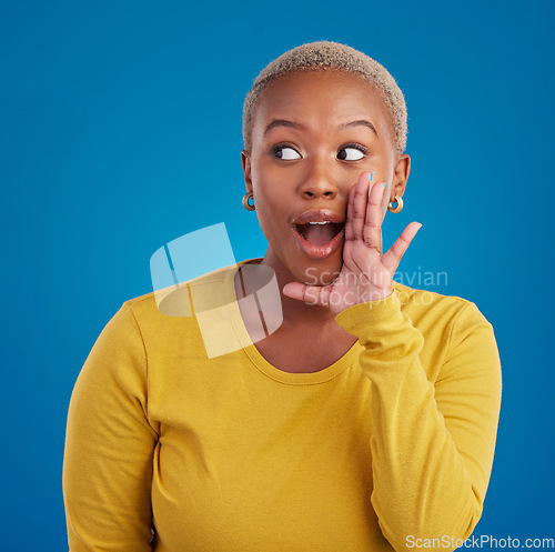 Image of Black woman, gossip and wow secret in studio with hand on face for sale announcement. African female model on a blue background to whisper message, news information or rumor about discount mockup