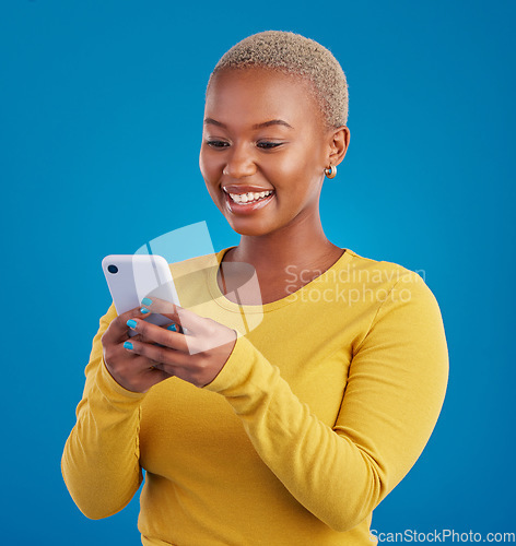 Image of Phone, typing and black woman in studio with smile for social media, text message and browse website. Communication mockup, technology and girl on internet, network and chat online on blue background