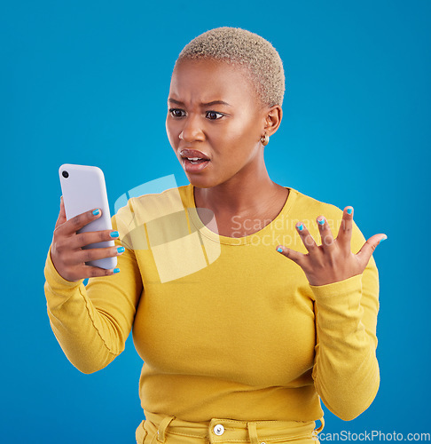 Image of Phone, wtf and confused black woman in studio for fake news, social media and text on blue background. Omg, scam and girl with smartphone notification for phishing alert, glitch or internet problem