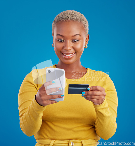 Image of Online shopping, credit card and black woman with phone in studio for ecommerce on blue background. Debit, fintech app and girl with subscription, membership or budget, payment and banking