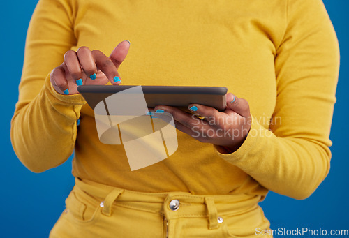 Image of Hands, tablet and search with a woman on a blue background in studio for research on the internet. Social media, tech and 5g with a female user reading data or information online for connectivity
