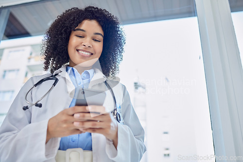 Image of Phone, healthcare and woman doctor with mobile app, network or telehealth service for hospital management. Medical professional or biracial person typing on cellphone or smartphone in clinic below