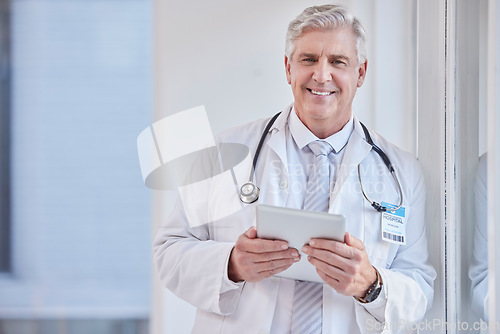 Image of Portrait, man and doctor with tablet, healthcare and career with success, connection and research in hospital. Face, mature male and medical professional with technology, online reading and diagnosis