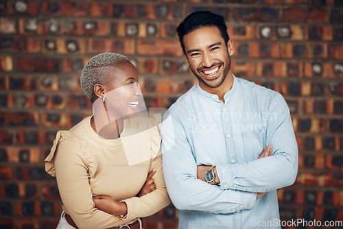 Image of Young, professional team and partnership, laughing with teamwork and arms crossed on wall background. Happy working together, creative pair and diversity, black woman and man, collaboration and trust