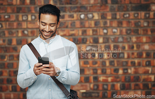 Image of Employee, startup and man with smartphone, wall and connection with happiness, success and typing. Male entrepreneur, creative and consultant with cellphone, communication and online reading for info