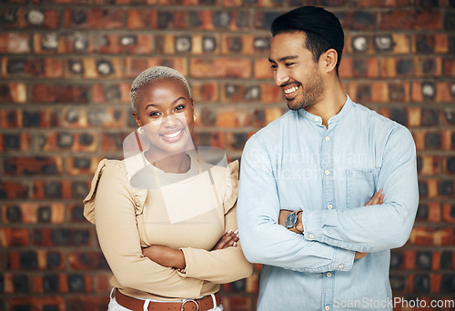 Image of Young, professional team and partnership, teamwork with smile and arms crossed on wall background. Happy working together, creative pair and diversity, black woman and man, collaboration and trust