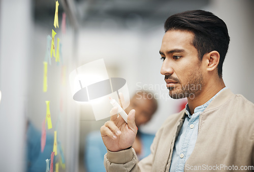 Image of Asian man, thinking and planning business schedule for brainstorming, project or tasks at the office. Thoughtful creative male with marker for idea strategy, decision or sticky note plan on board