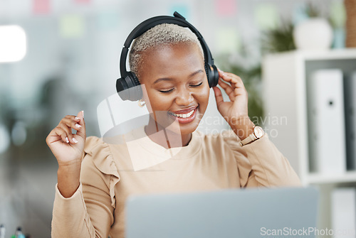 Image of Dance, happy and black woman with music during work, radio break and listening to audio. Smile, stress relief and dancing African employee with headphones for streaming a podcast, songs and playlist