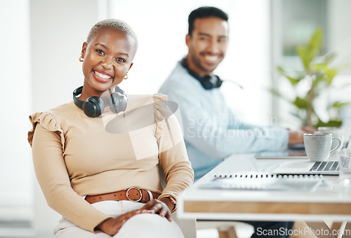 Image of Portrait, business smile and black woman in office with coworker and pride for career or profession. Boss, headphones and happy, confident and proud African female entrepreneur with success mindset.