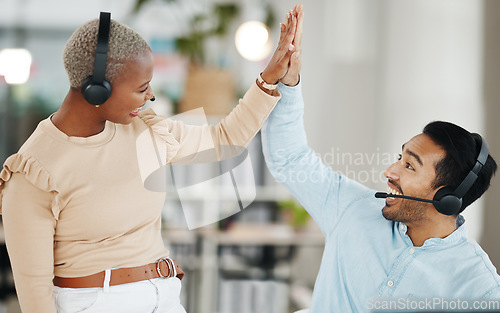 Image of Asian man, call center and team celebration with high five for winning, bonus or sale in telemarketing at office. Happy and excited male consultant touching hand of colleague for win or promotion