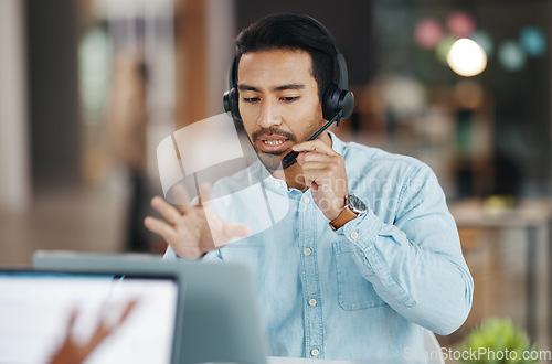 Image of Asian man, call center and consulting with headphones on laptop in customer service or desktop support at office. Male consultant agent talking with headset on PC for telemarketing or online advice