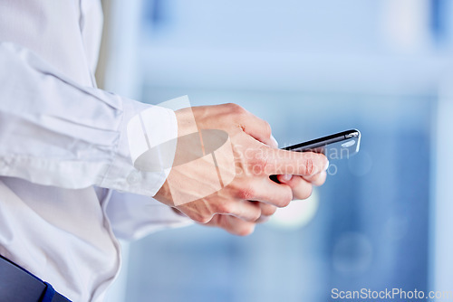 Image of Hands, phone and texting with a business man in his office, closeup for communication or networking. Mobile, contact and internet with a male employee typing a text message or making a call