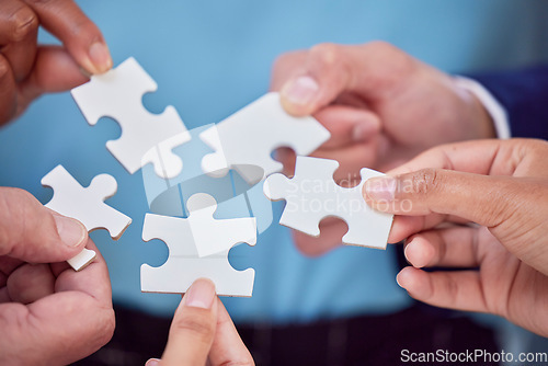 Image of Hands, puzzle and team closeup of collaboration, creative and partnership, unity and cooperation. Zoom, hand and jigsaw formula by business people with synergy, teamwork and integration or strategy