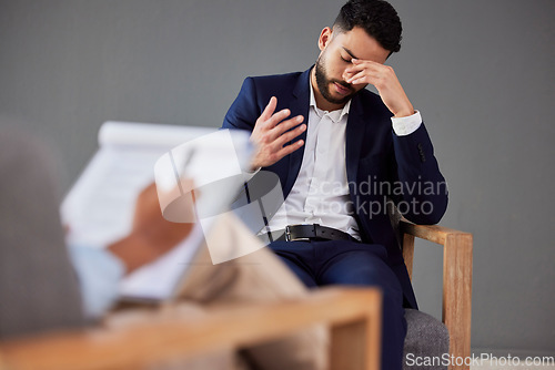 Image of Sad man consulting therapist in therapy or counseling for mental health, depression or stress help, advice and support. Checklist, evaluation and psychologist with business person or patient talking