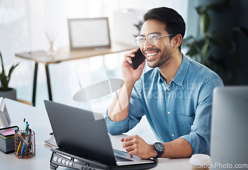 Image of Phone call, founder and business man laughing and happy on mobile conversation as communication in company office. Laptop, cellphone and excited startup entrepreneur in discussion and networking