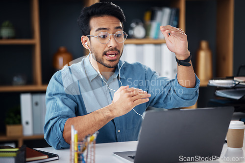 Image of Asian man, laptop and consulting in video call for communication with earphones at office desk. Male employee explaining project plan in webinar, virtual meeting or talking on computer at workplace