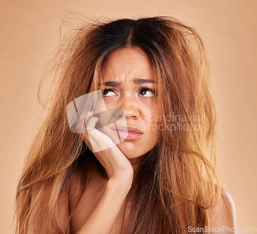 Image of Sad face, hair loss and woman in studio isolated on a brown background for thinking. Idea, keratin damage or angry female model with haircare, messy hairstyle or split ends after salon treatment fail