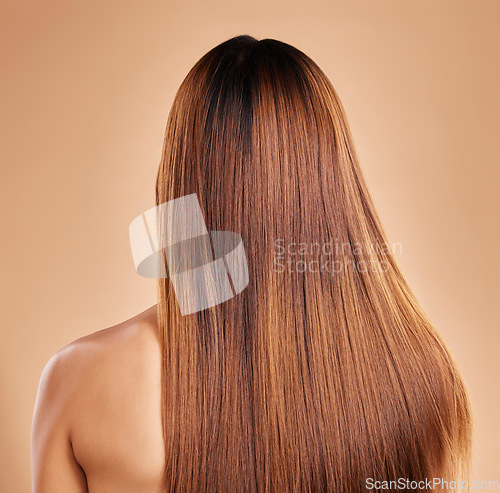 Image of Haircare, beauty and back of woman with straight hair in studio isolated on brown background. Balayage, wellness and female model with salon treatment for growth, keratin texture or healthy hairstyle