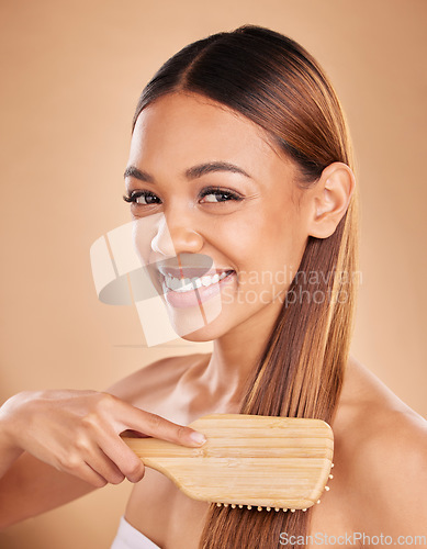 Image of Woman, beauty and hair brush portrait or smile for growth and shine for healthy texture on brown background. Aesthetic female happy in studio brushing for natural keratin treatment haircare results