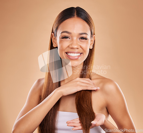 Image of Woman, beauty and portrait with hair texture for growth and shine shampoo on a brown background. Smile of aesthetic female happy in studio for natural keratin treatment wellness with haircare results