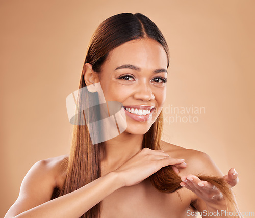 Image of Woman, portrait and happy with hair texture with growth and shine shampoo on a brown background. Aesthetic female excited in studio for natural keratin treatment and wellness with self care and smile