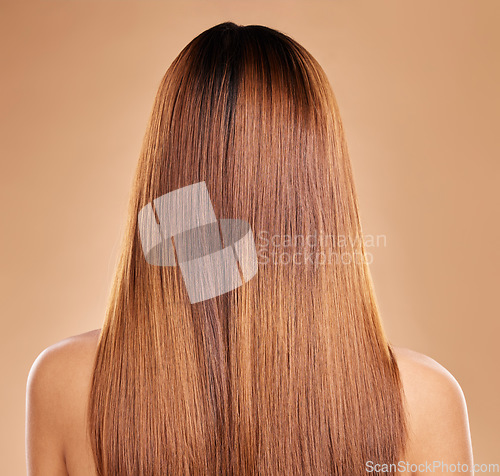 Image of Haircare, beauty and back of woman with straight hair in studio isolated on brown background. Balayage, wellness and female model with salon treatment for growth, keratin texture or healthy hairstyle