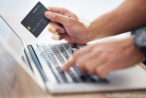 Image of Hands, laptop and credit card for ecommerce, online shopping or electronic purchase on wooden desk. Hand of shopper working on computer for internet banking, app or wireless transaction on table