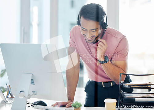 Image of Happy asian man, call center and headphones by computer for consulting, customer service or support at office desk. Friendly male consultant agent smile with headset mic by PC in telemarketing advice