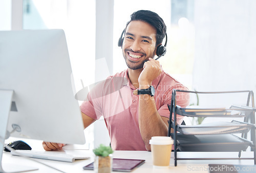 Image of Happy asian man, call center and headphones by computer for consulting, customer service or support at office desk. Portrait of friendly male consultant with headset mic by PC in telemarketing advice