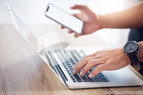 Image of Man, hands and laptop with phone mockup for digital marketing, advertising or social media on wooden desk. Hand of male typing on computer keyboard with smartphone screen in networking communication