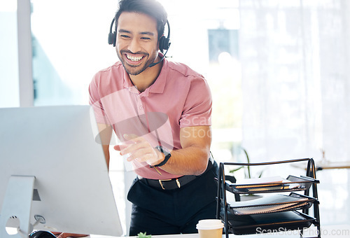 Image of Asian man, call center and consulting with headphones on computer for customer service or desktop support at office. Happy male consultant agent talking with headset on PC for telemarketing or advice