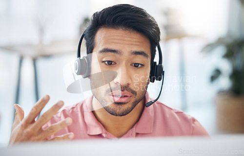 Image of Asian man, call center and consulting with headphones on computer for customer service, help or support at office. Male consultant agent talking with headset on PC for telemarketing or online advice