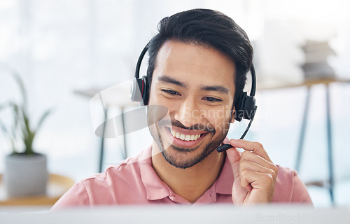 Image of Asian man, call center and smile with headset mic on computer for consulting, customer service or support at office. Happy male consultant with headphones by PC for telemarketing or online advice