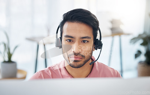 Image of Serious asian man, call center and headset on computer for consulting, customer service or support at office. Focused male consultant with headphones by desktop PC for telemarketing or online advice