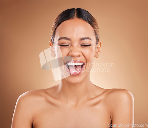 Image of Beauty, face and a woman laughing in studio for skincare with dermatology, cosmetics or makeup. Happy aesthetic female model on a brown background for self care, skin glow and facial wellness