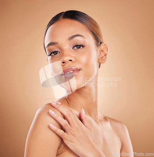 Image of Beauty, portrait and a woman face with skin care glow and shine in studio on a brown background. Aesthetic female model hand for spa facial, natural dermatology cosmetics and wellness results